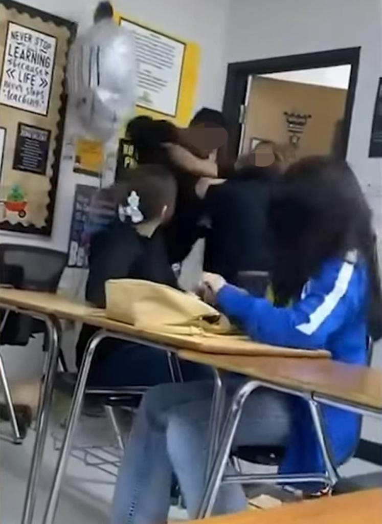 One student hurled a couple of punches at his classmate and grabbed the teacher, who inserted herself in between the students before he threw her aside and unleashed several more punches.