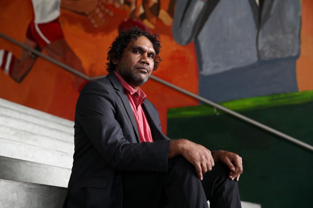 Vincent Namatjira poses in front of his foyer wall commission at the Museum of Contemporary Art on February 25, 2021.