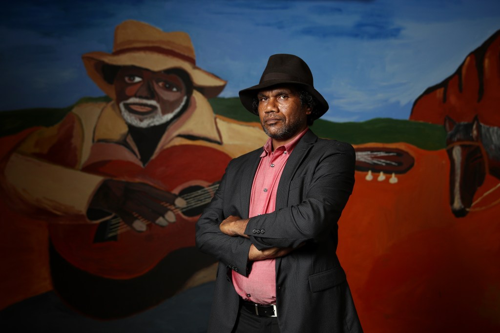 Vincent Namatjira poses in front of his  foyer wall commission at the  Museum of Contemporary Art on February 25, 2021 in Sydney, Australia. 