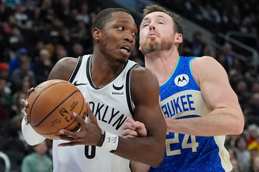 Brooklyn Nets' Lonnie Walker IV tries to get past Milwaukee Bucks' Pat Connaughton during the first half of an NBA basketball game Thursday, March 21, 2024, in Milwaukee.