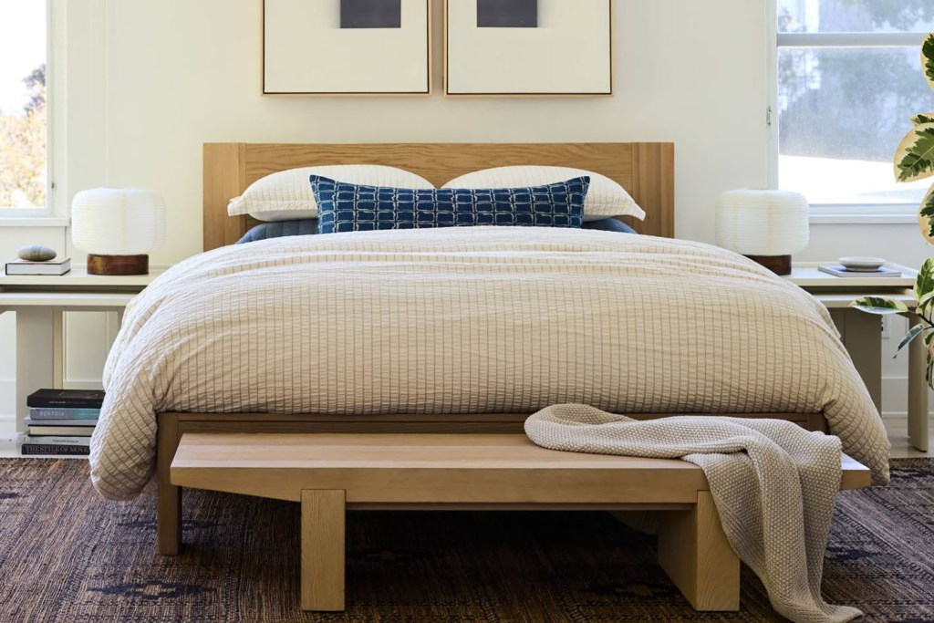 A bed with a wooden bench from West Elm