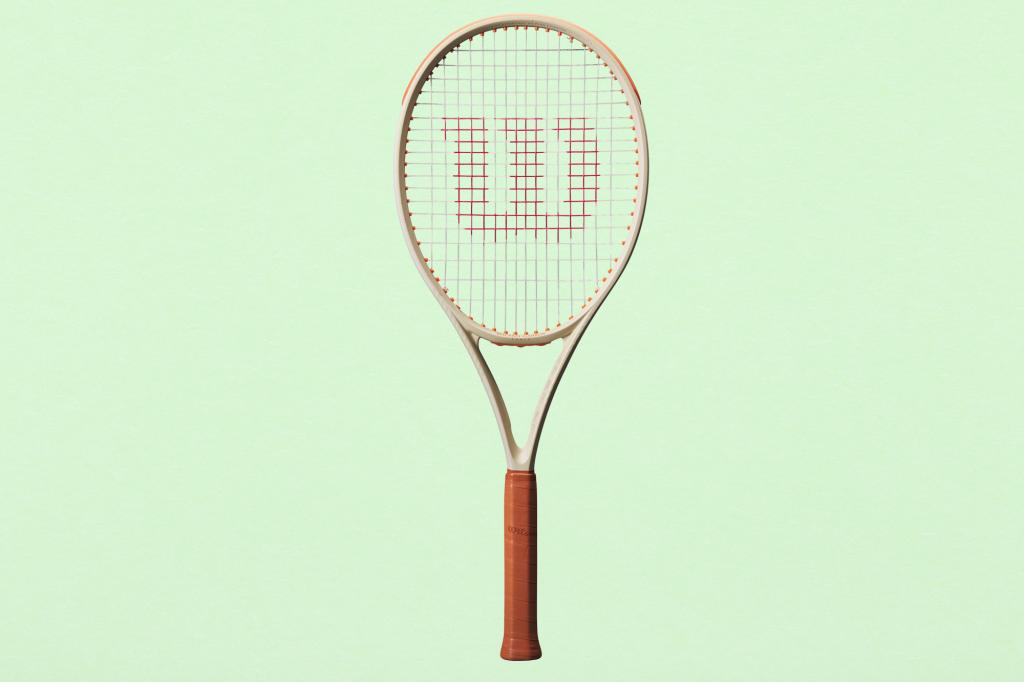 A tennis racket with a W logo on a fresh green paper texture background