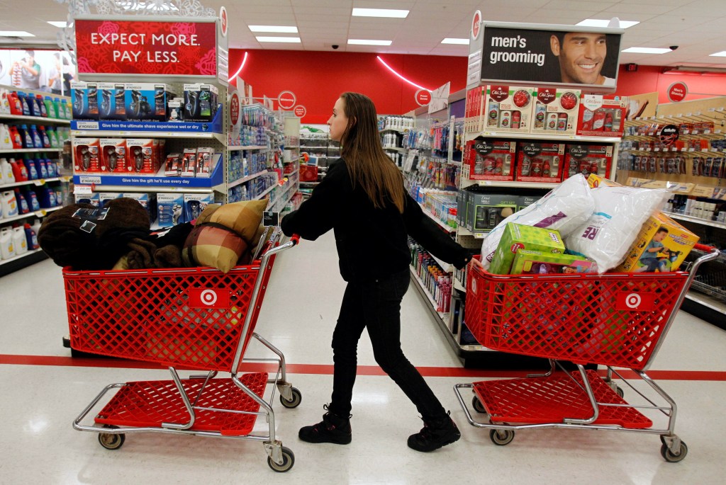 A Target employee pulls shopping carts through the aisle of a Target store in Torrington, Conn.