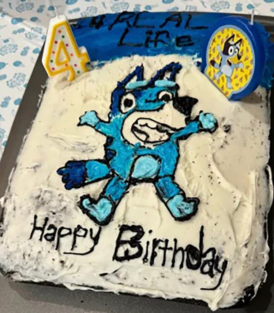 A handmade Bluey-themed birthday cake made by a mother for her daughter's 4th birthday