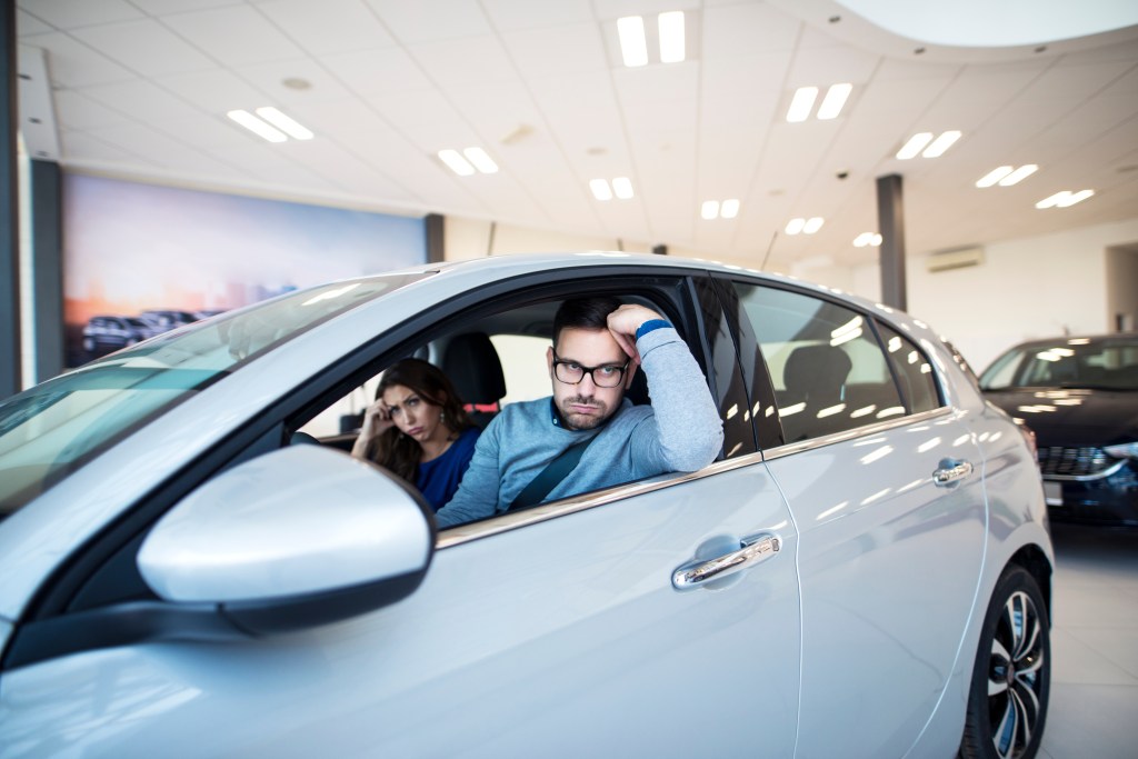 Young couple can not agree about new car they want to buy.