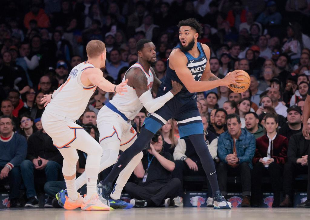 New York Knicks guard Donte DiVincenzo and forward Julius Randle double teaming Minnesota Timberwolves center Karl-Anthony Towns during a basketball game at Madison Square Garden