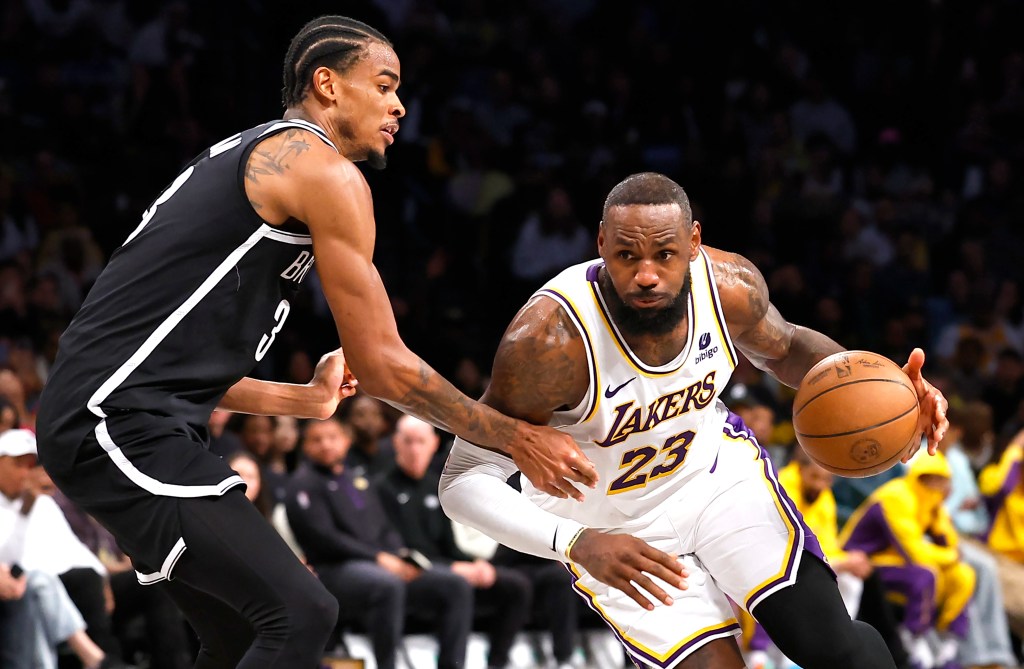 Los Angeles Lakers forward LeBron James (23) drives to the basket against Brooklyn Nets center Nic Claxton (33) during the second half at the Barclays Center.  Sunday, March 31, 2024 
