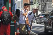 A large group of migrants hang out between 7th and 8th Ave's on 41 Street in Manhattan, New York.