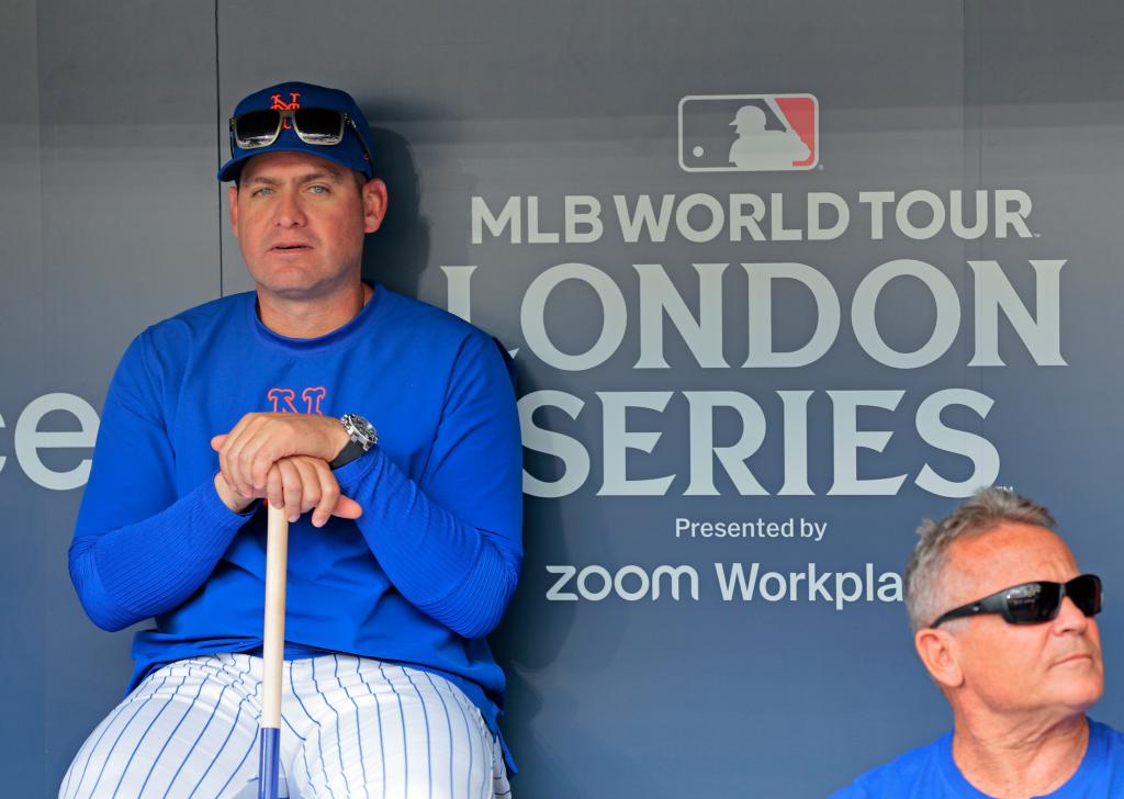 New York Mets manager Carlos Mendoza #64 sitting in the dugout during the Mets workout at London Stadium.