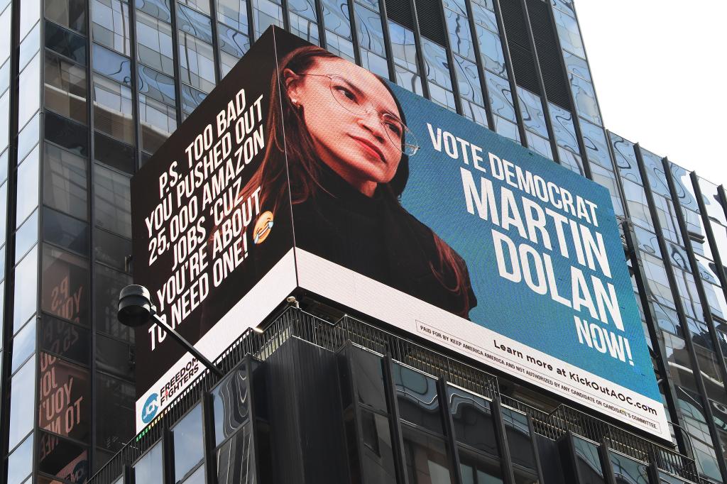 Electronic billboard displaying Martin Dolan's ads against AOC on the side of a building at 1500 Broadway in Times Square