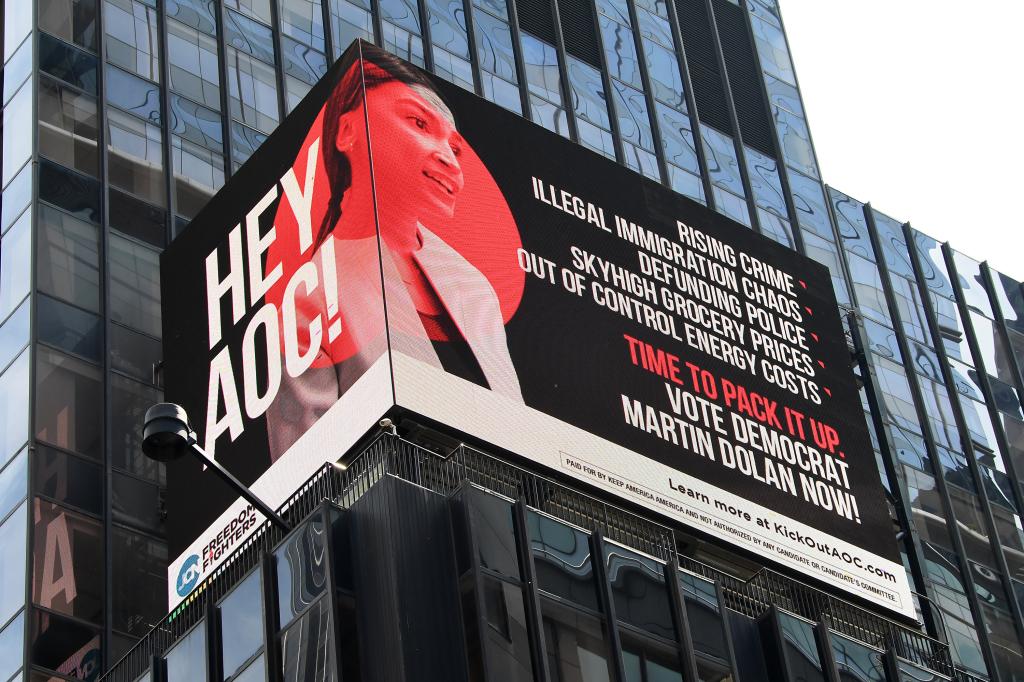 Electronic billboard running ads against AOC on the side of a building at 1500 Broadway in Times Square