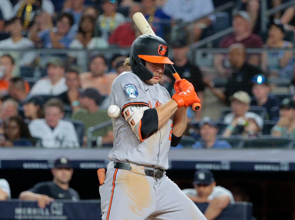 Baltimore Orioles shortstop Gunnar Henderson #2, is hit by a pitch thrown by New York Yankees pitcher Victor González