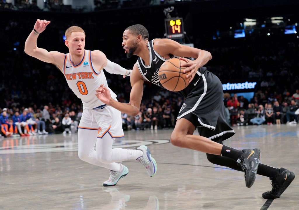Mikal Bridges #1 of the Brooklyn Nets drives down court as Donte DiVincenzo #0 of the New York Knicks defends during the first period.