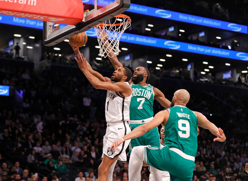 Mikal Bridges #1 of the Brooklyn Nets goes up for a shot as Jaylen Brown #7 of the Boston Celtics defends during the first half.  