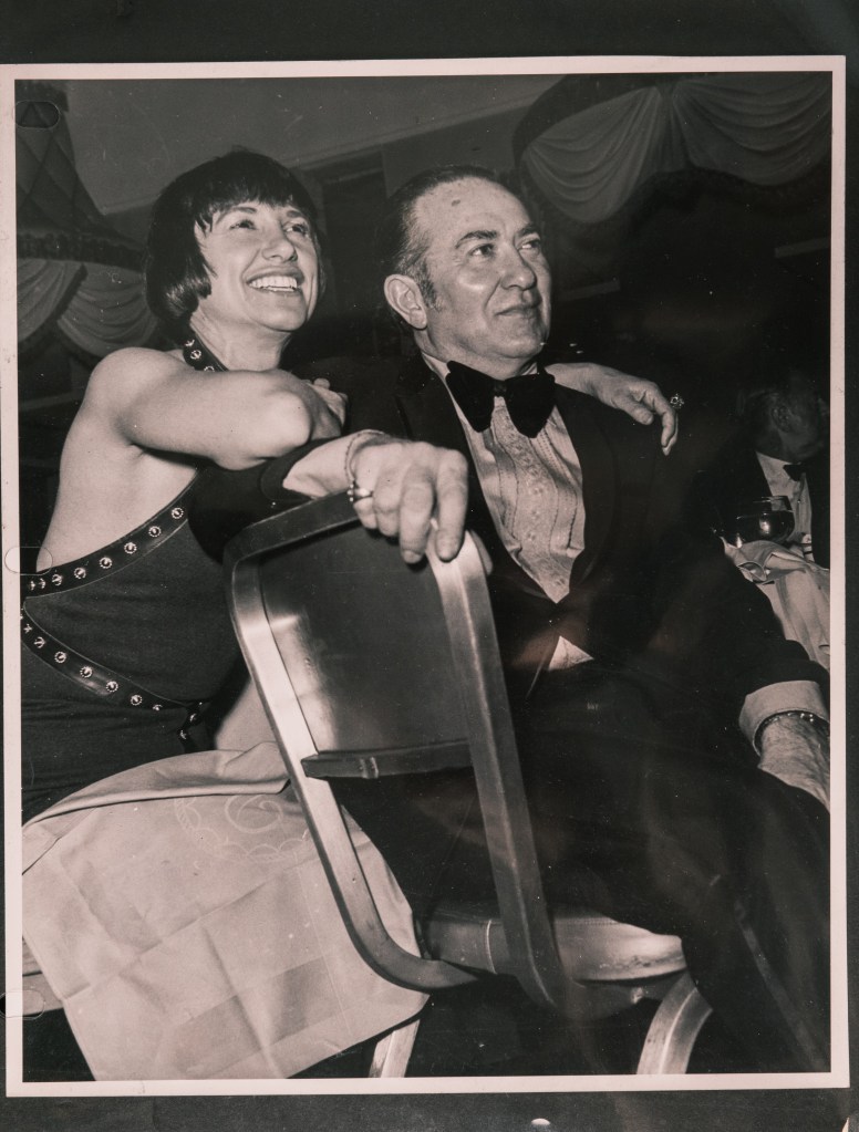 Michelle and Ralph Cohen sitting at a table in formal wear in an old black and white photo. 