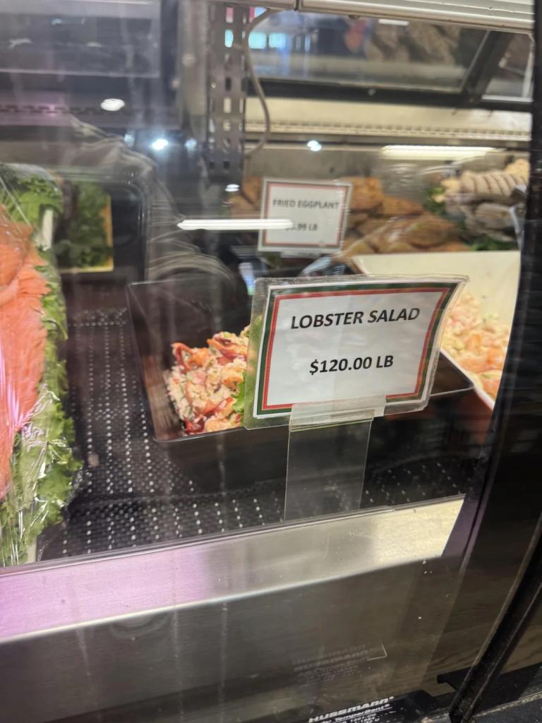 Locals took to social media to deride the price of the lobster salad, seen here in a refrigerated case in a store with a sign that says "lobster salad $120 Lb"
