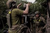 In this photo provided by the 24th Mechanised brigade press service, Ukrainian soldiers fire 120 mm mortar towards Russian position on the front line at Chasiv Yar in Donetsk region, Ukraine, Saturday, June 15, 2024.