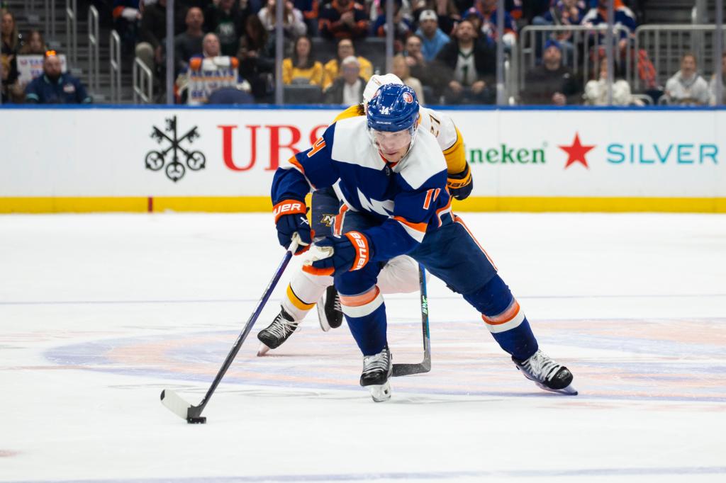 Bo Horvat #14 of the New York Islanders handles puck against Ryan McDonagh #27 of the Nashville Predators.
