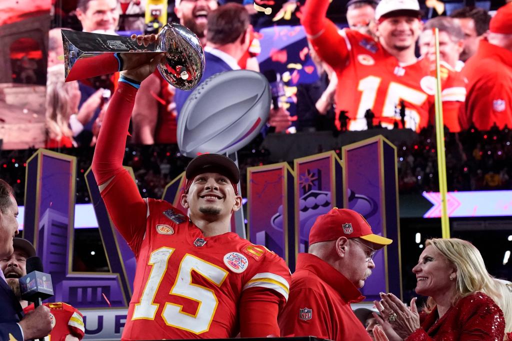 Kansas City Chiefs' quarterback Patrick Mahomes holding the trophy celebrating Super Bowl LVIII victory against the San Francisco 49ers at Allegiant Stadium