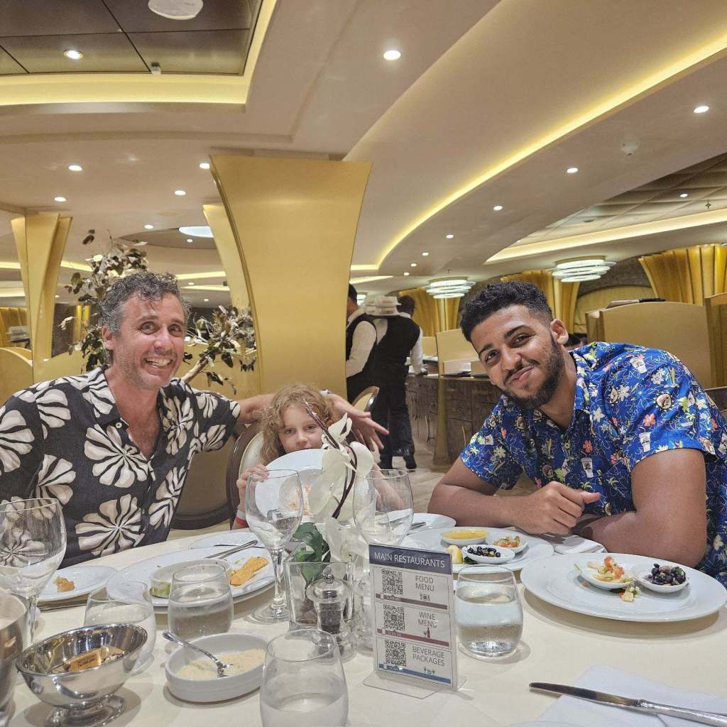 Nagel, Topaz, 7, and Tyler, 20, pose for a picture at a table at a restaurant in the Bahamas