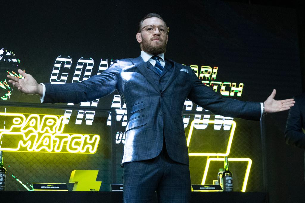 UFC fighter Conor McGregor gesturing with arms out during a 2019 press conference in Moscow, Russia.