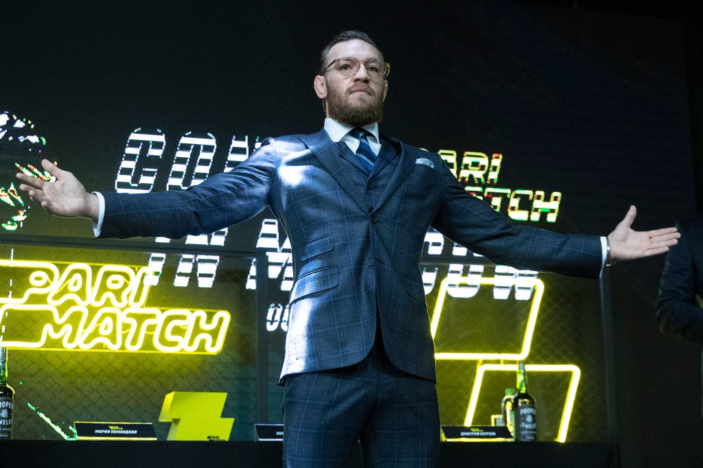 UFC fighter Conor McGregor gesturing with arms out during a 2019 press conference in Moscow, Russia.