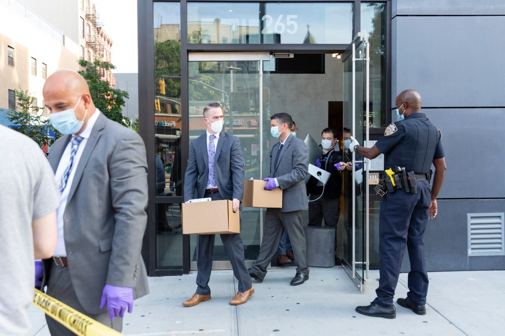 Police remove boxes of evidence from Fahim Saleh's apartment in 2020.