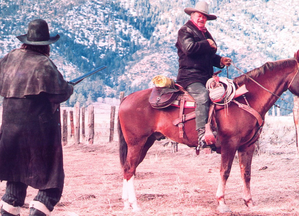 THE SHOOTIST, John Wayne (right), 1976.