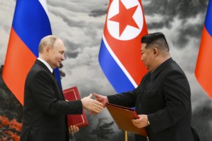 Russian President Vladimir Putin and North Korea's leader Kim Jong Un exchange documents during a signing ceremony of the new partnership in Pyongyang, North Korea.