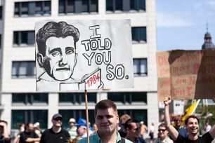 Protestor holding up a banner during a demonstration in the city center of Frankfurt, Germany.