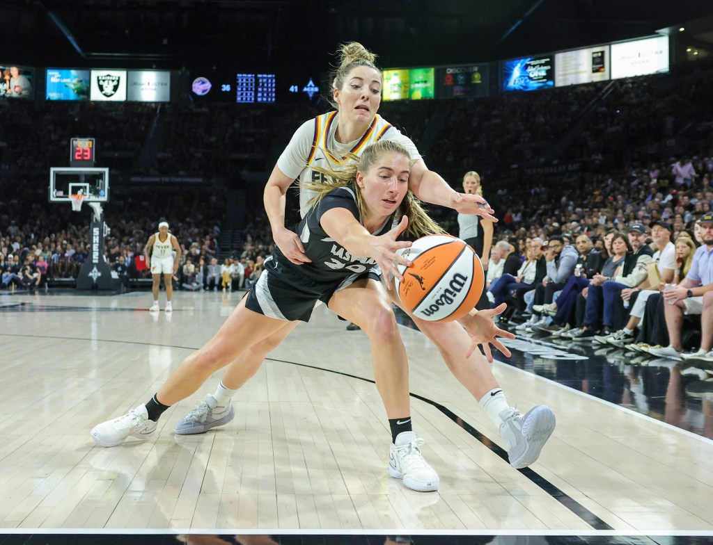 Kate Martin of Las Vegas Aces and Katie Lou Samuelson of Indiana Fever competing for a loose basketball ball during a game