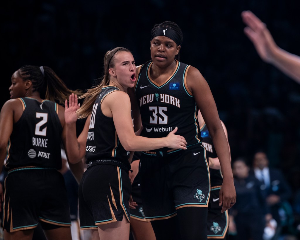 Sabrina Ionescu #20 of the New York Liberty and Jonquel Jones #35 of the New York Liberty react the during their home opener vs Indiana Fever at Barclays Center.