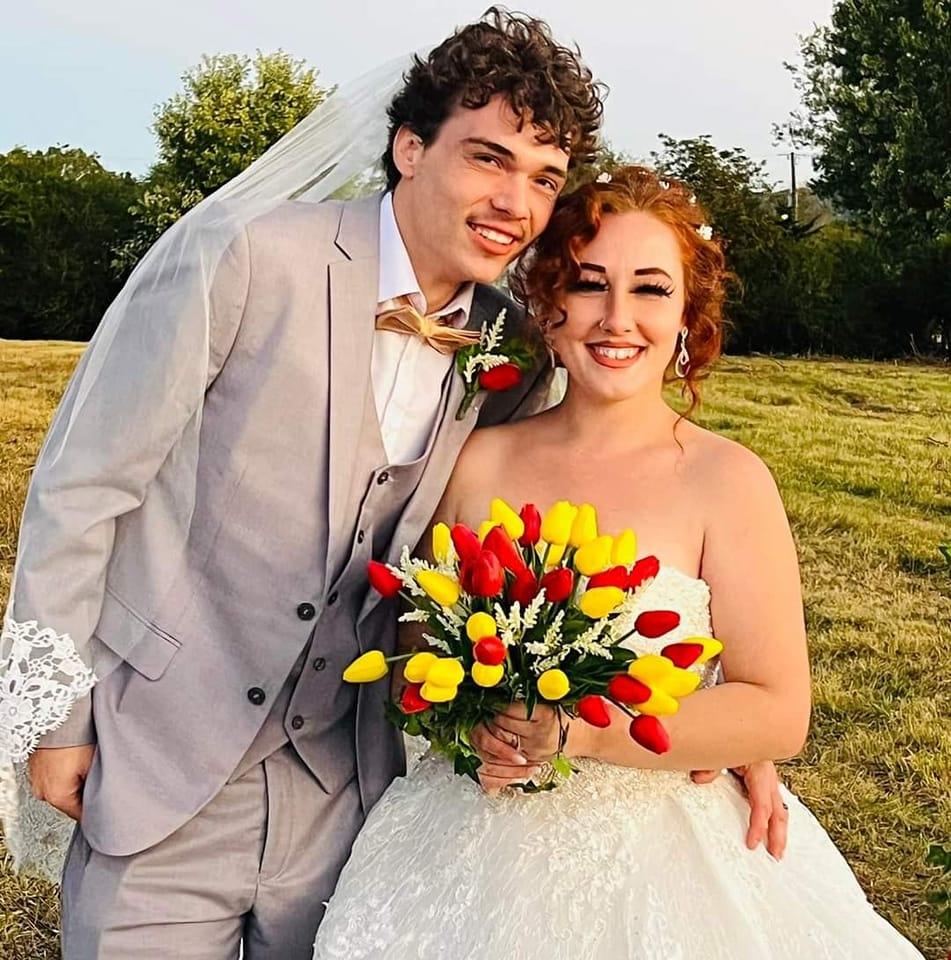 Jonathon and Cassandra Jones posing at their wedding.