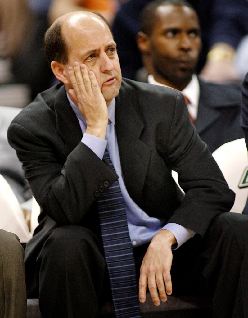 Houston Rockets coach Jeff Van Gundy reacting to a call during an NBA game against the New Orleans Hornets, holding his hand to his face
