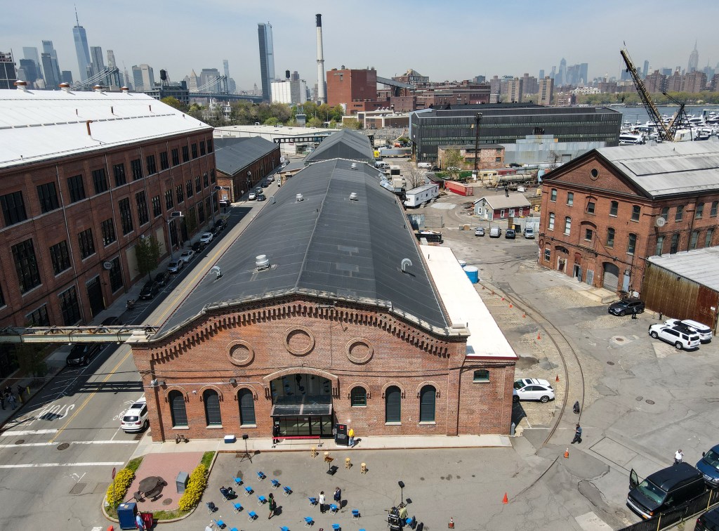 Wide overhead of NYC Mayor Bill de Blasio cutting the ribbon at the opening of the newly renovated Nanotronics building in the Brooklyn Navy Yard.