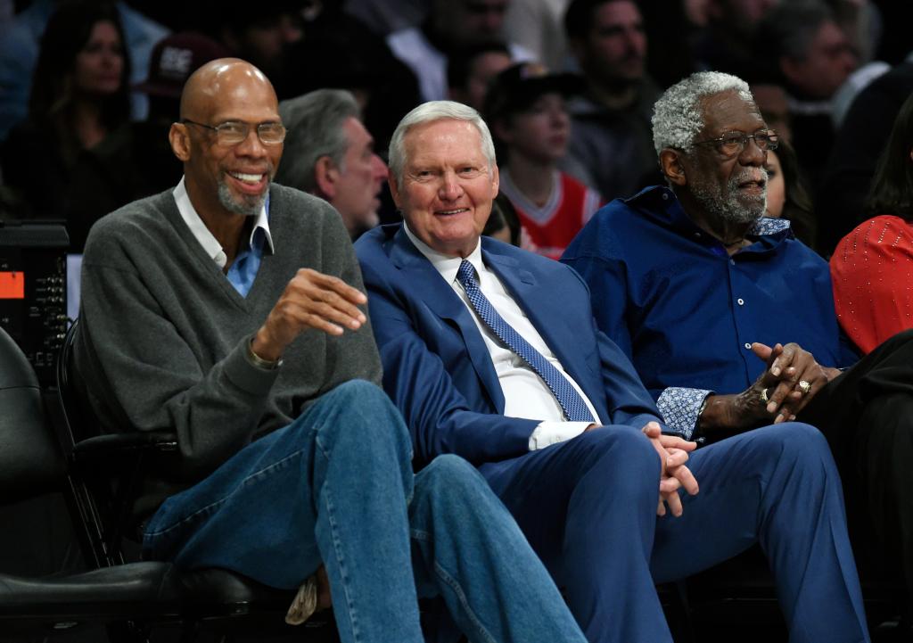(L-R) NBA legends Kareem Abdul-Jabbar, Jerry West and Bill Russell watch during the first half of an NBA All-Star basketball game, Sunday, Feb. 18, 2018, in Los Angeles. 