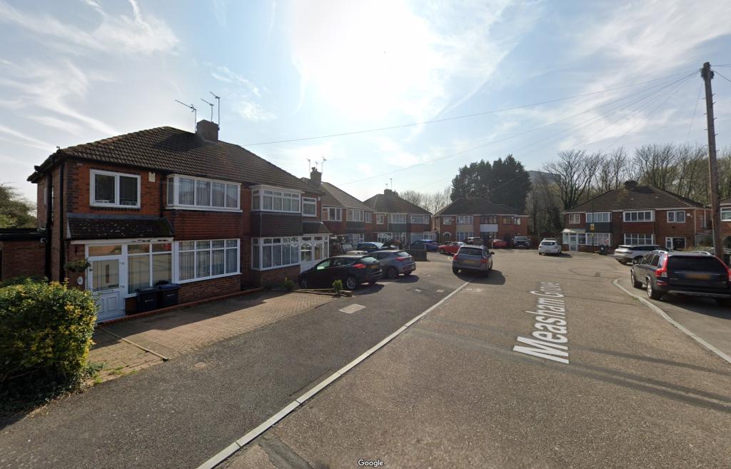 View of Measham Grove, Acocks Green. A street with homes and cars