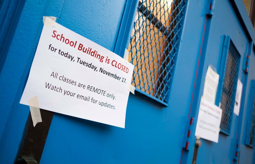 A sign on the door of a closed public school in Brooklyn, New York, USA, 18 November 2020.