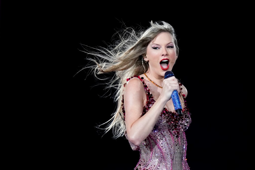 Taylor Swift singing onstage. 