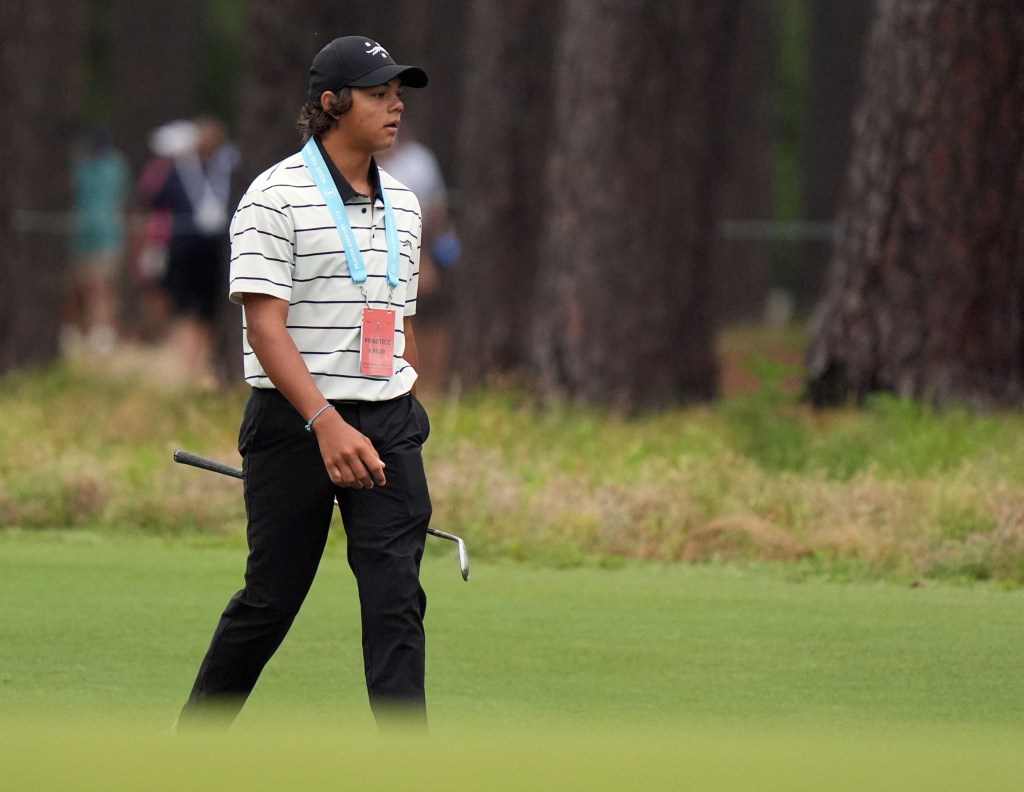 Charlie Woods walks up the 10th hole during a practice round with his dad Tiger Woods for the U.S. Open golf tournament at Pinehurst No. 2.