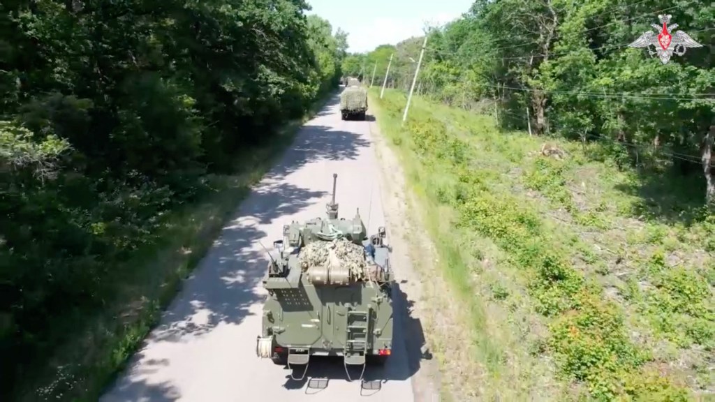 Military vehicles drive along a road during the second stage of tactical nuclear drills of the armed forces of Russia and Belarus