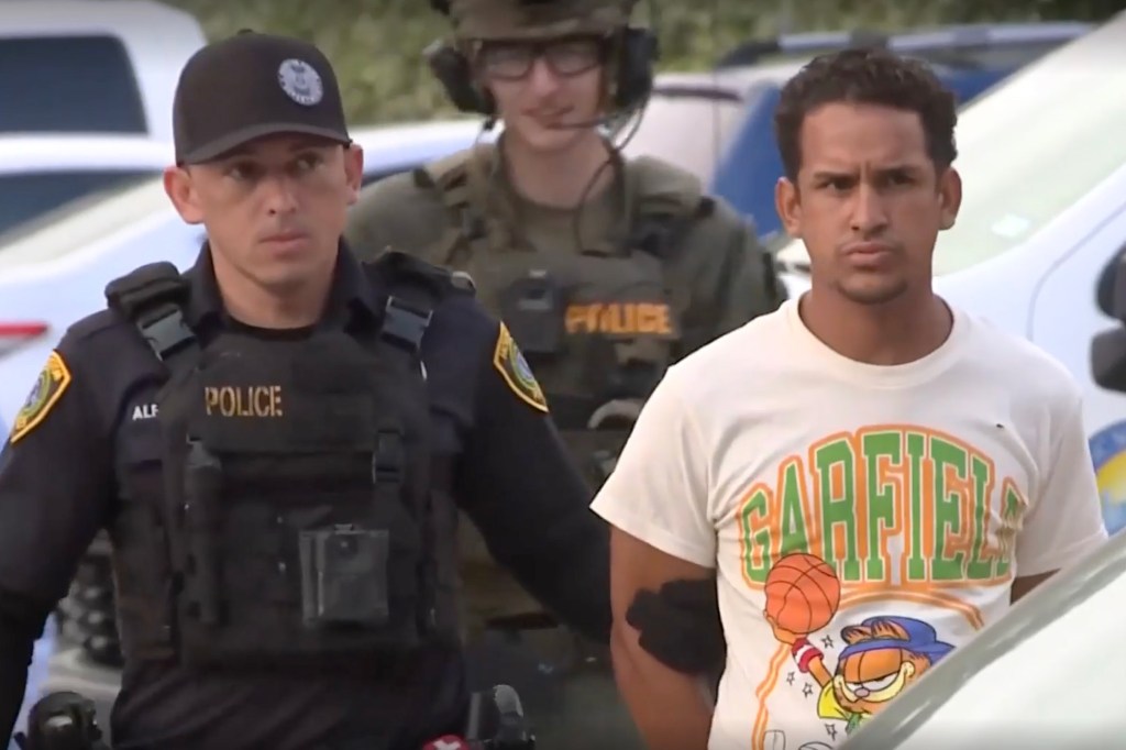 Franklin Jose Pena Ramos, 26, is pictured in handcuffs being escorted by police.