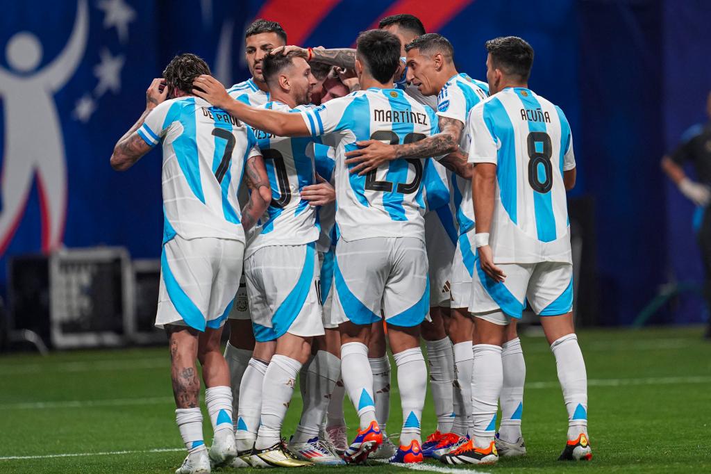 Argentina soccer team players, including Leandro Paredes, celebrating a goal by Lautaro Martinez against Canada at Mercedes-Benz Stadium during the Copa America match.