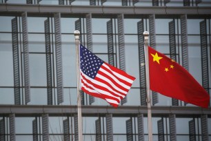Chinese and U.S. flags flutter outside the building of an American company in Beijing, China.
