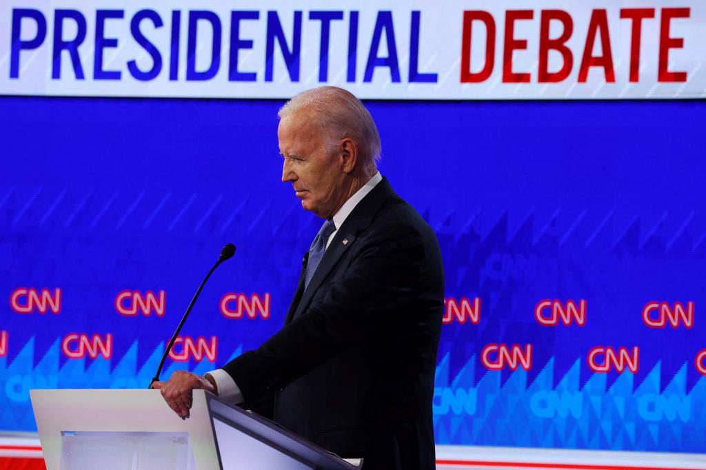 Democrat presidential candidate U.S. President Joe Biden listens as Republican presidential candidate former U.S. President Donald Trump speaks during their debate in Atlanta.