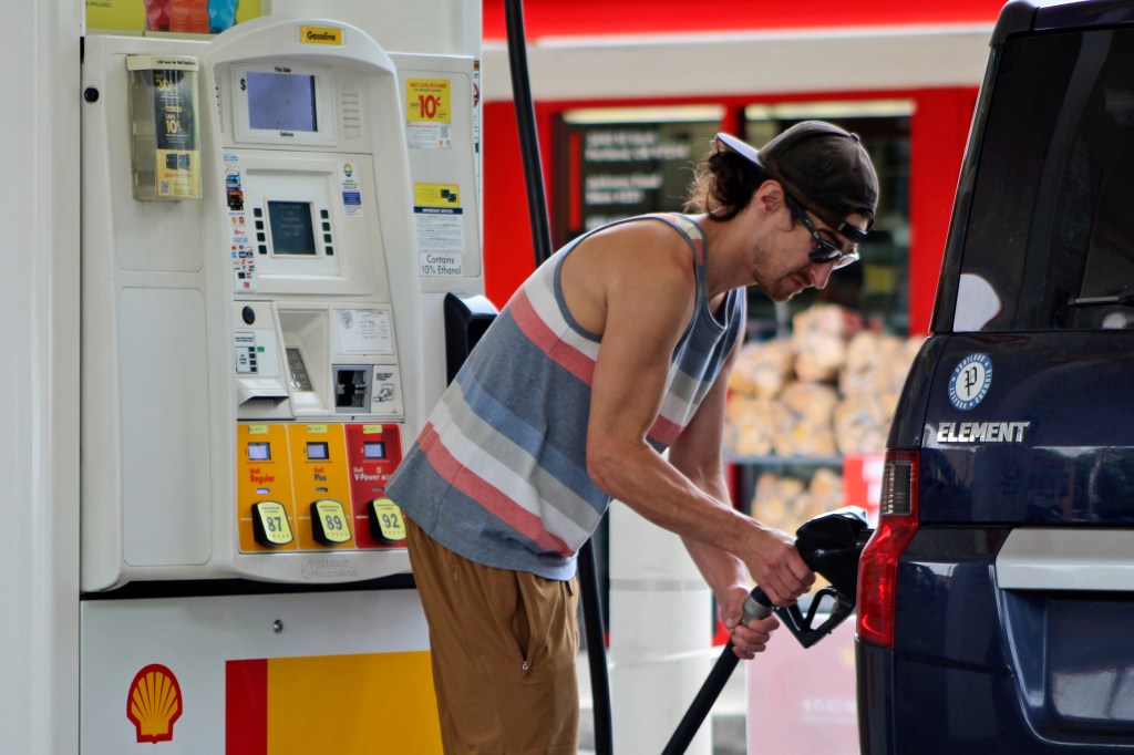 Driving filling up car with gas.