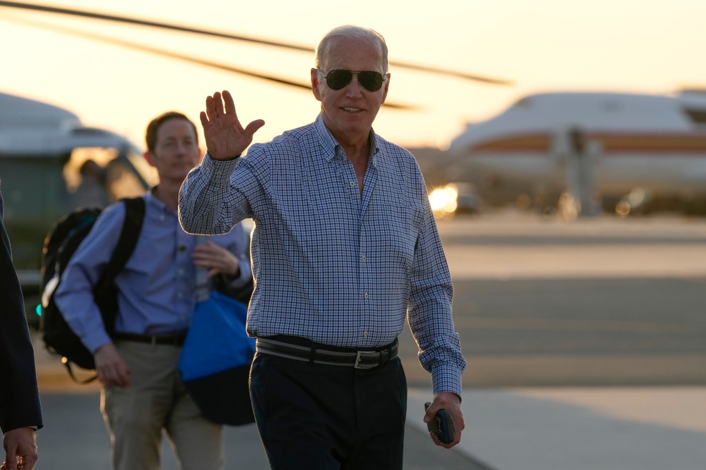 President Joe Biden waves as he walks to board Air Force One at Dover Air Force Base in Delaware, Thursday, June 20, 2024.