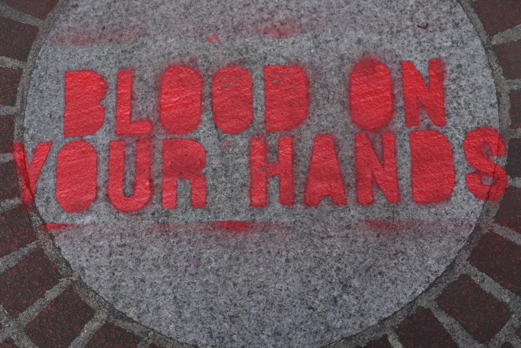 "Blood on your hands" seen painted on the ground outside a vandalized home