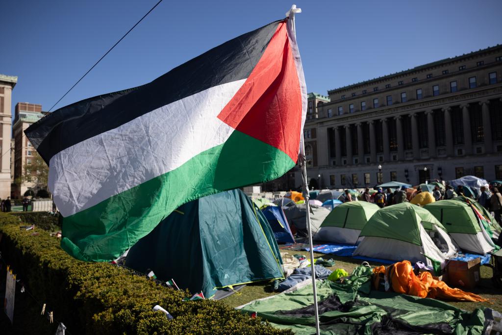 Palestine flag flying over tents on the Columbia lawn