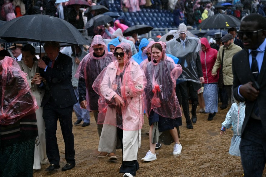 People shelter from the rain at Horse Guards Parade.